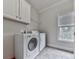 Functional laundry room with washer, dryer, and overhead cabinets at 215 Haleys Ct, Woodstock, GA 30188