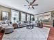 Spacious living room with hardwood floors, multiple windows, a comfortable sectional sofa, and an inviting atmosphere at 215 Haleys Ct, Woodstock, GA 30188