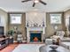 Cozy living room showcasing a fireplace with decorative mantel, hardwood floors, and a comfortable seating area at 215 Haleys Ct, Woodstock, GA 30188