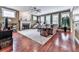 Open-concept living room featuring hardwood floors, large windows, a fireplace, and stylish furniture for a modern look at 215 Haleys Ct, Woodstock, GA 30188