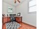 Bright home office with custom wood cabinets, desk, and a patterned rug at 215 Haleys Ct, Woodstock, GA 30188