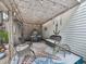 Cozy covered patio featuring ample seating and stylish decor for outdoor relaxation and entertainment at 215 Haleys Ct, Woodstock, GA 30188