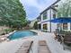 Backyard pool featuring a patio and comfortable lounge seating, perfect for relaxation and entertainment at 215 Haleys Ct, Woodstock, GA 30188