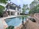 Refreshing in-ground pool and backyard featuring a screened deck at 215 Haleys Ct, Woodstock, GA 30188