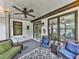 Cozy screened-in porch featuring wicker furniture and an overhead ceiling fan at 215 Haleys Ct, Woodstock, GA 30188