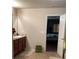 Well-lit bathroom with a vanity, mirror, and an open doorway to the Primary bedroom at 6074 Locklear Way, Douglasville, GA 30134