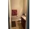Cozy half bath with a brown vanity and patterned towels at 6074 Locklear Way, Douglasville, GA 30134