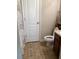 Bathroom with tile floor, toilet, shower/tub, and wooden vanity at 6074 Locklear Way, Douglasville, GA 30134