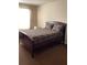 Bedroom featuring a queen size bed with dark frame at 6074 Locklear Way, Douglasville, GA 30134