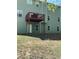 View of a two-story house featuring an exterior back deck, green siding, and well-maintained lawn at 6074 Locklear Way, Douglasville, GA 30134