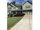Charming two-story home with a well-manicured lawn and a spacious driveway at 6074 Locklear Way, Douglasville, GA 30134