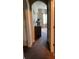 Hallway with carpeting, tan walls, archway leading to bright, sunlit room at 6074 Locklear Way, Douglasville, GA 30134
