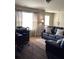 Living room with a leather sofa and an office desk area at 6074 Locklear Way, Douglasville, GA 30134