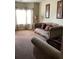 Cozy living room featuring a comfortable sofa, neutral tones, and natural light from the window at 6074 Locklear Way, Douglasville, GA 30134