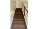 Carpeted staircase with white and wooden banister leading upwards at 6074 Locklear Way, Douglasville, GA 30134