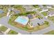Aerial view of community pool with parking lot and surrounding houses in a residential area at 7730 Tiberon Pkwy, Cumming, GA 30028