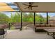 Covered patio with outdoor furniture and a view of the beautifully landscaped backyard, perfect for entertaining at 7730 Tiberon Pkwy, Cumming, GA 30028