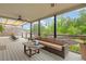 Relaxing outdoor space with a comfortable sofa, coffee table, and a view of the landscaped backyard at 7730 Tiberon Pkwy, Cumming, GA 30028