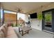 Relaxing covered patio with a ceiling fan, outdoor seating, and a grill for entertaining guests at 7730 Tiberon Pkwy, Cumming, GA 30028