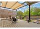 Inviting outdoor patio with comfortable seating and a view of the landscaped backyard with a trampoline at 7730 Tiberon Pkwy, Cumming, GA 30028