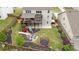 A large backyard featuring a deck, patio, playground, trampoline, and landscaped garden at 7730 Tiberon Pkwy, Cumming, GA 30028