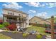 Beautiful backyard featuring a deck, play area, trampoline, and landscaped garden beds at 7730 Tiberon Pkwy, Cumming, GA 30028