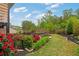 Beautifully landscaped backyard with vibrant red roses, lush greenery, and a well-maintained lawn at 7730 Tiberon Pkwy, Cumming, GA 30028