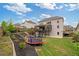Large backyard with a covered deck, a trampoline, landscaping, and a fenced perimeter at 7730 Tiberon Pkwy, Cumming, GA 30028