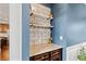 Stylish bar area with granite countertops, shelving, and space for stemware and beverage storage at 7730 Tiberon Pkwy, Cumming, GA 30028