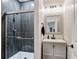 Modern bathroom featuring tiled shower with glass door and a stylish vanity at 7730 Tiberon Pkwy, Cumming, GA 30028