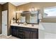 Bathroom featuring a double vanity, large mirror and separate bathtub at 7730 Tiberon Pkwy, Cumming, GA 30028