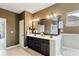 Elegant bathroom featuring a double vanity, large mirror, and separate bathtub at 7730 Tiberon Pkwy, Cumming, GA 30028