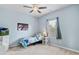 Charming bedroom features neutral carpet and a ceiling fan for added comfort at 7730 Tiberon Pkwy, Cumming, GA 30028