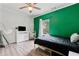 Eclectic bedroom with modern hanging chair, and black bed and emerald accent wall at 7730 Tiberon Pkwy, Cumming, GA 30028