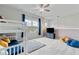 Spacious bedroom featuring a bunk bed, ceiling fan, plush carpeting, and large windows at 7730 Tiberon Pkwy, Cumming, GA 30028