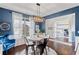 Bright dining room features a modern chandelier, a round table with seating for four, and blue accent wall at 7730 Tiberon Pkwy, Cumming, GA 30028