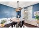 Dining room with a round table and modern chandelier and a large window allowing for natural light at 7730 Tiberon Pkwy, Cumming, GA 30028