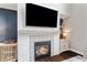 Close-up of the fireplace with tile surround in living room with modern decor at 7730 Tiberon Pkwy, Cumming, GA 30028