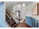 Inviting foyer features a staircase, decorative wallpaper, and elegant hardwood floors at 7730 Tiberon Pkwy, Cumming, GA 30028
