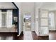 Foyer showcasing hardwood floors, a stylish rug, and an open doorway at 7730 Tiberon Pkwy, Cumming, GA 30028