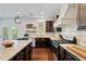 Open concept kitchen with granite countertops, stainless steel appliances, and a gas range at 7730 Tiberon Pkwy, Cumming, GA 30028
