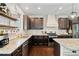 Kitchen features granite countertops, stainless steel appliances, dark wood cabinets, and hardwood floors at 7730 Tiberon Pkwy, Cumming, GA 30028
