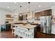 Modern kitchen features dark cabinets, stainless steel appliances, and granite countertops at 7730 Tiberon Pkwy, Cumming, GA 30028