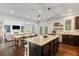 Bright, open kitchen featuring granite countertops, stainless steel appliances, and a large island with seating at 7730 Tiberon Pkwy, Cumming, GA 30028