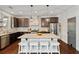 Kitchen island, stainless steel appliances, and hardwood floors at 7730 Tiberon Pkwy, Cumming, GA 30028