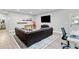 Finished basement living room with foosball table, fireplace, and comfortable leather sofa at 7730 Tiberon Pkwy, Cumming, GA 30028