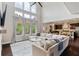 Open-concept living room with dark wood floors and abundant natural light at 7730 Tiberon Pkwy, Cumming, GA 30028