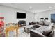 The spacious living room features a large TV, fireplace, and comfortable leather sofas at 7730 Tiberon Pkwy, Cumming, GA 30028