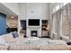 Cozy living room with fireplace, large windows, and a comfortable sofa at 7730 Tiberon Pkwy, Cumming, GA 30028