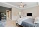 Well-lit main bedroom with tray ceiling, neutral carpet, and convenient built-in bookcase at 7730 Tiberon Pkwy, Cumming, GA 30028